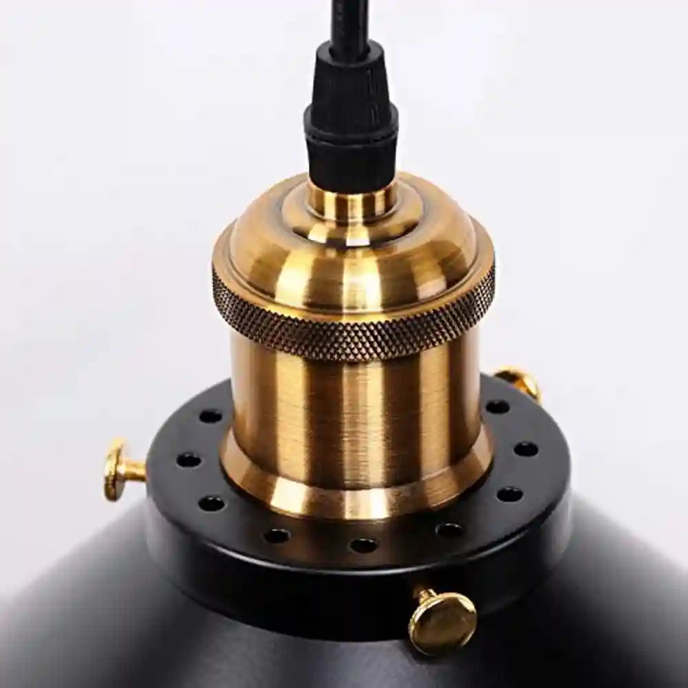 Black industrial loft-style pendant light with brass socket and knurled detailing.