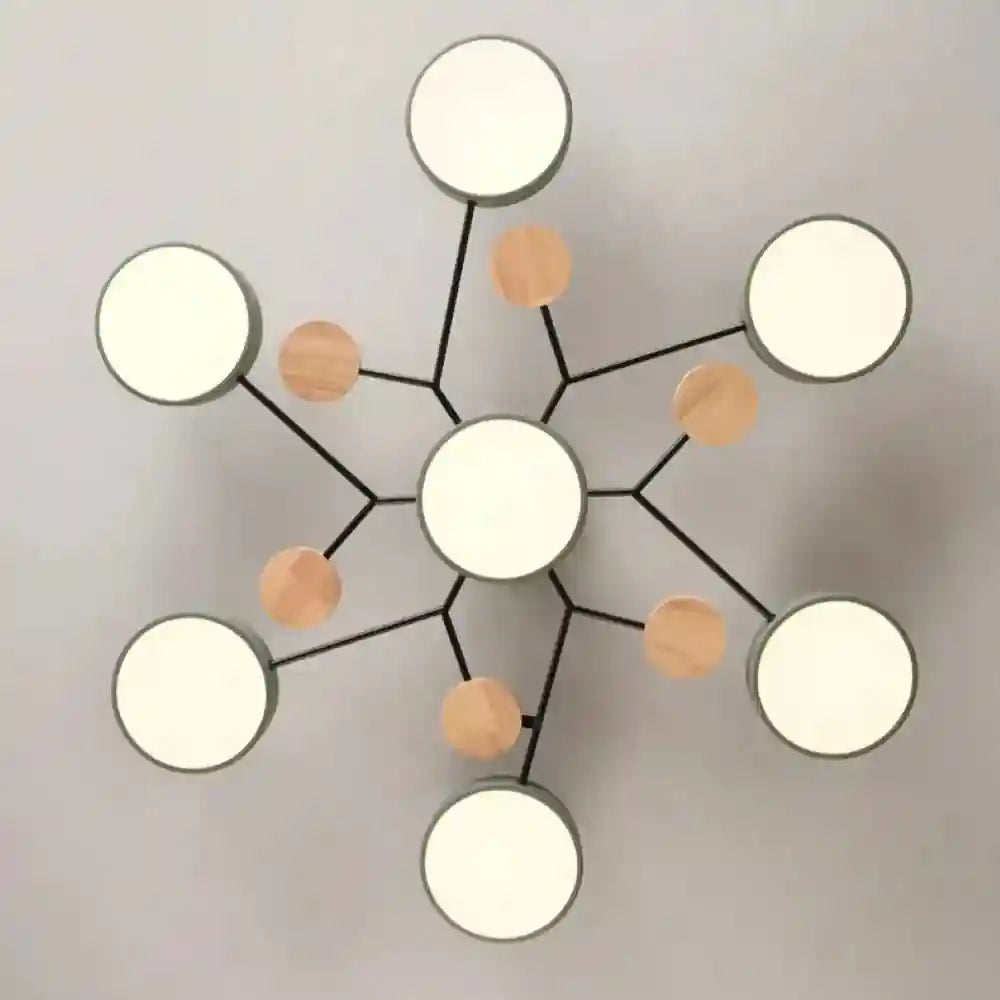Modern black metal ceiling light with six round white diffusers and wooden accent spheres.