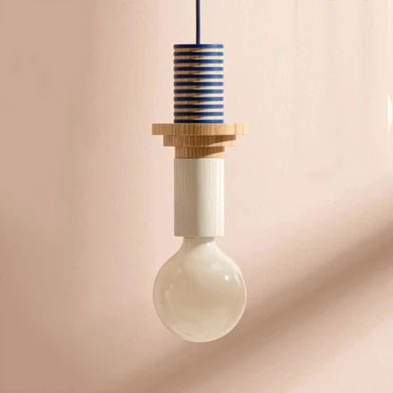 Nordic wood pendant light with stacked blue and natural wood elements and large round bulb.