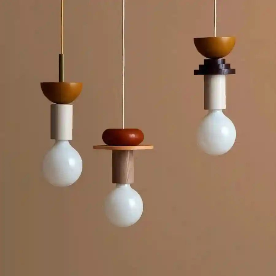 Nordic wooden pendant lights in orange and beige tones with white bulb and modern geometric shapes.