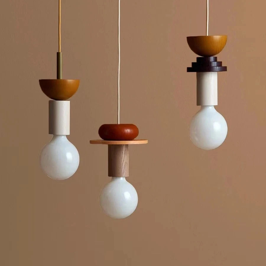 Nordic wooden pendant lights in orange and beige tones with white bulb and modern geometric shapes.