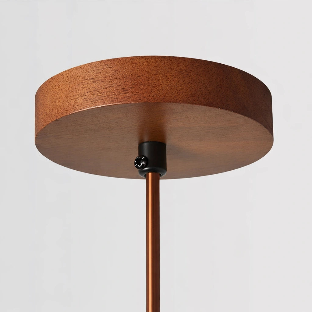 Round wooden ceiling canopy with copper rod and black metal fixture details.